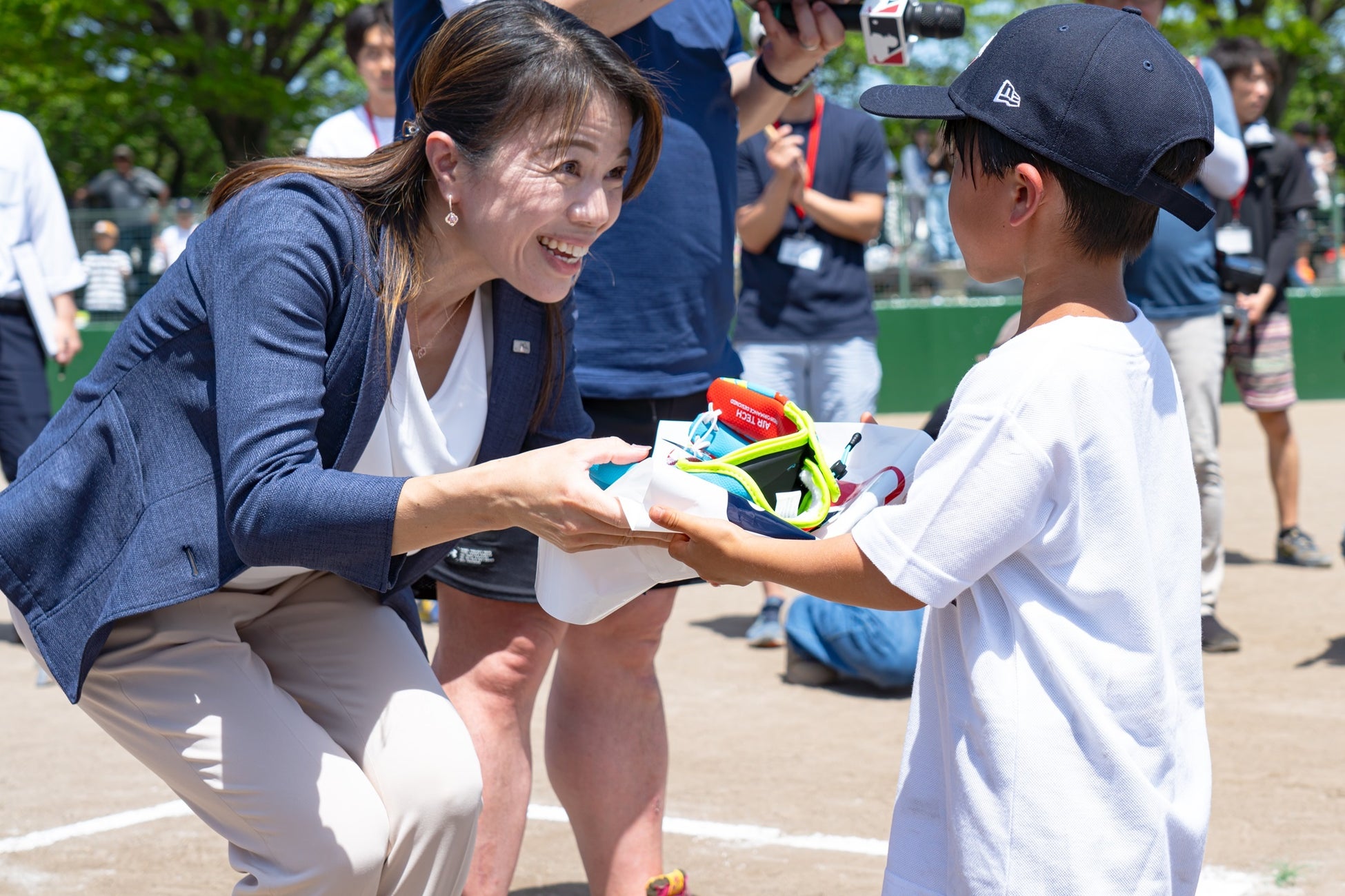 グローブ贈呈式の様子（MLB Japan代表 川上紗実から、各市町代表の子どもたちにグローブを贈呈）